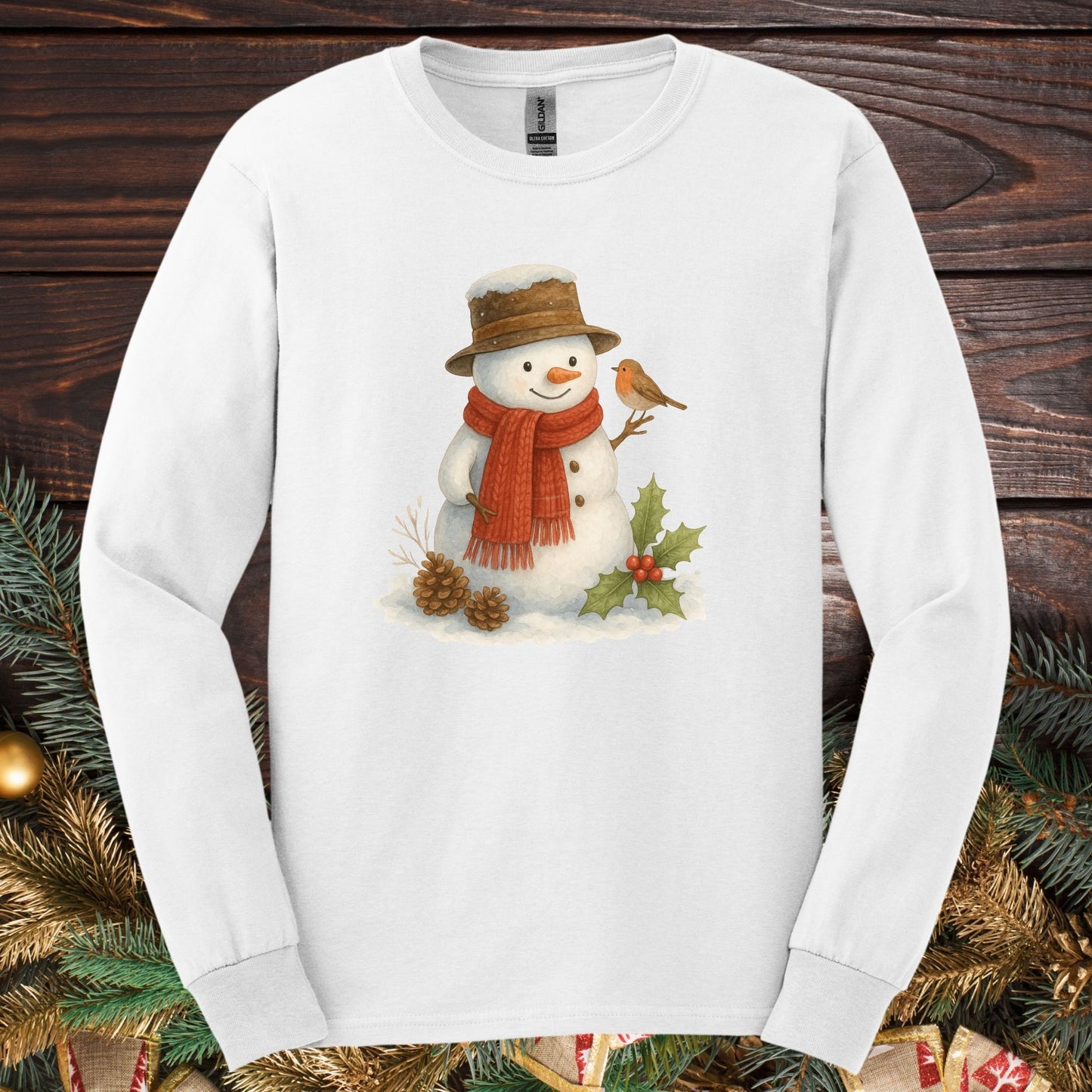 White Gildan long sleeve tee with a rustic watercolor snowman, holly, and sparrow.