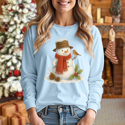 Light blue long-sleeve tee with a rustic watercolor snowman, sparrow, holly, and pinecones.