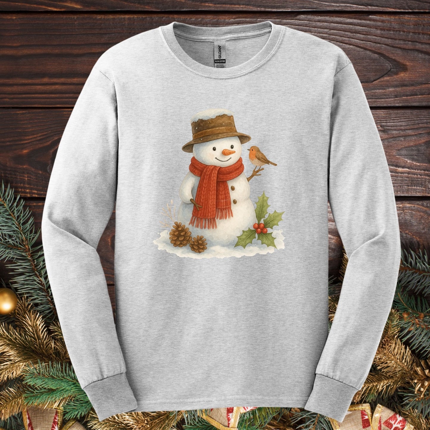 Ash Gildan 2400 long sleeve tee with a rustic watercolor snowman, holly, and sparrow design.