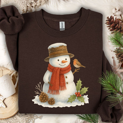 Dark Chocolate Gildan 18000 sweatshirt with a watercolor snowman, holly, pinecones, and a sparrow.