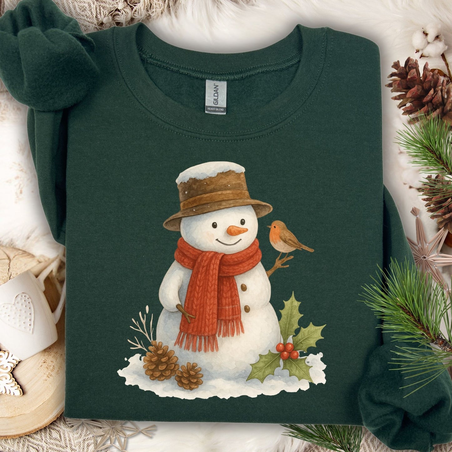 Forest Green Gildan 18000 sweatshirt with a watercolor snowman, sparrow, holly, and pinecones.