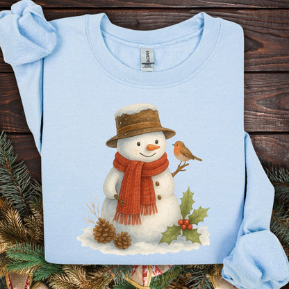 Light blue Gildan 18000 sweatshirt with a watercolor snowman, sparrow, holly, and pinecones.