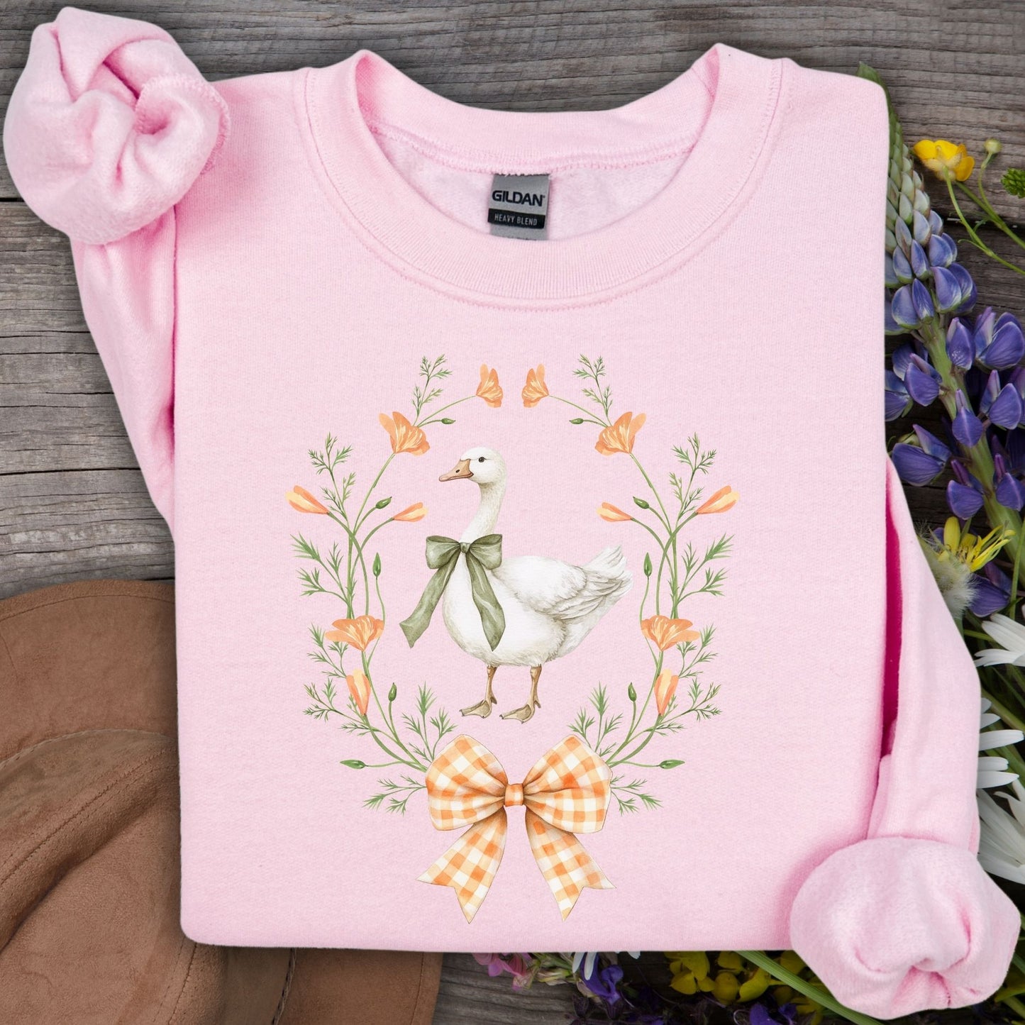 Light pink Gildan crewneck sweatshirt with a farmhouse goose, wildflower, and gingham bow design.
