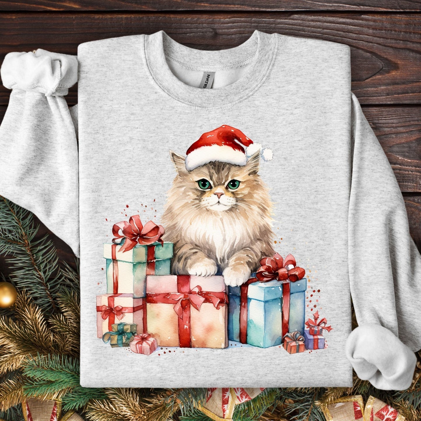 Ash Gildan sweatshirt with a watercolor cat in a Santa hat on colorful Christmas presents.
