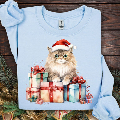Light blue Gildan sweatshirt with a watercolor cat in a Santa hat surrounded by Christmas presents.