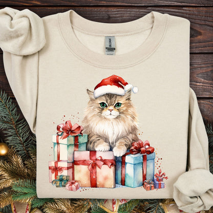Sand Gildan sweatshirt with a watercolor cat in a Santa hat on colorful Christmas presents.