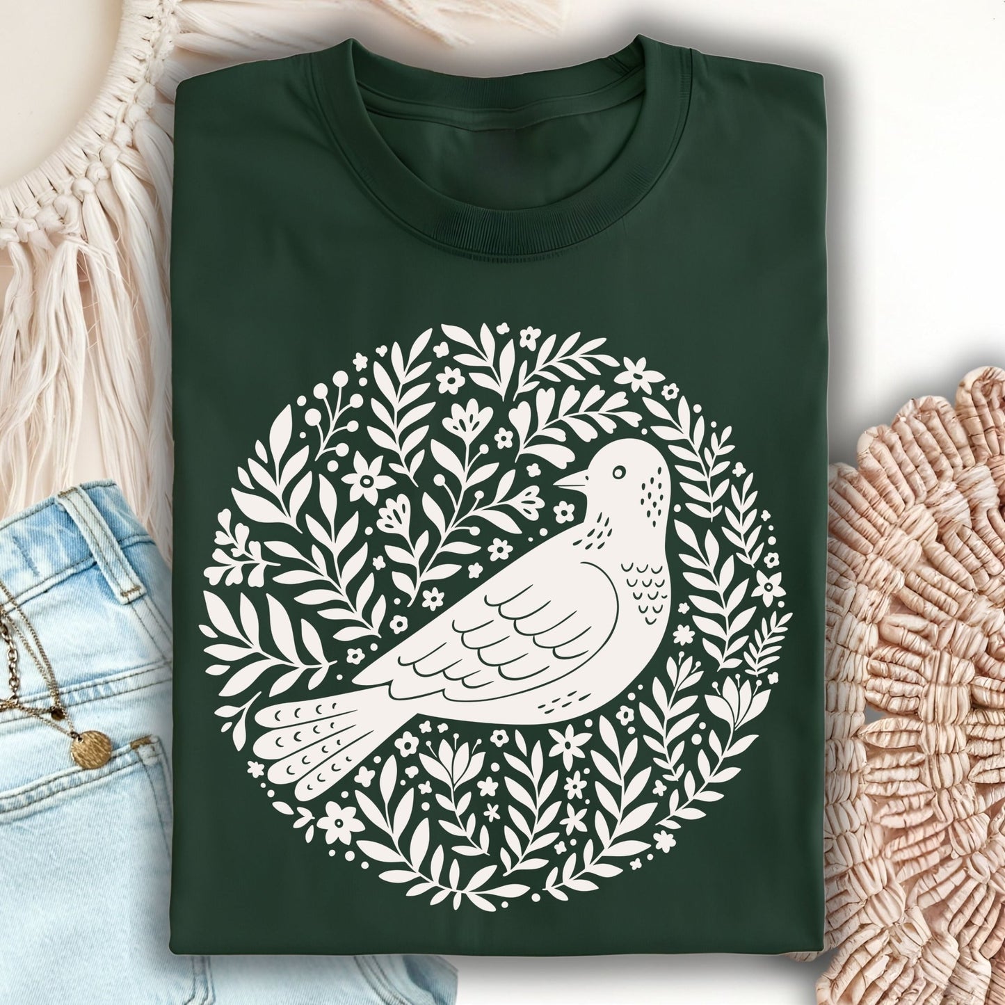 Forest Green S-size t-shirt with a white Scandinavian bird and floral wreath design.