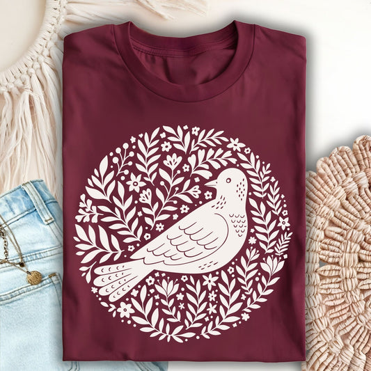 Maroon S-sized t-shirt with a white Scandinavian bird and floral wreath design.