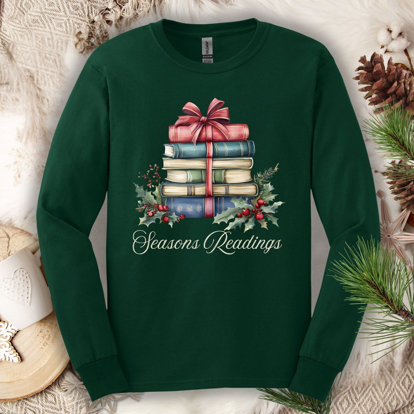 Forest Green long sleeve tee with watercolor stacked Christmas books, red bow, holly, and "Seasons Readings" text.