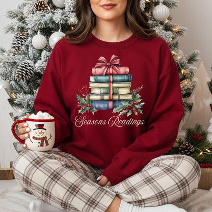 Red "Seasons Readings" sweatshirt with a watercolor stack of Christmas books, holly, and pine.