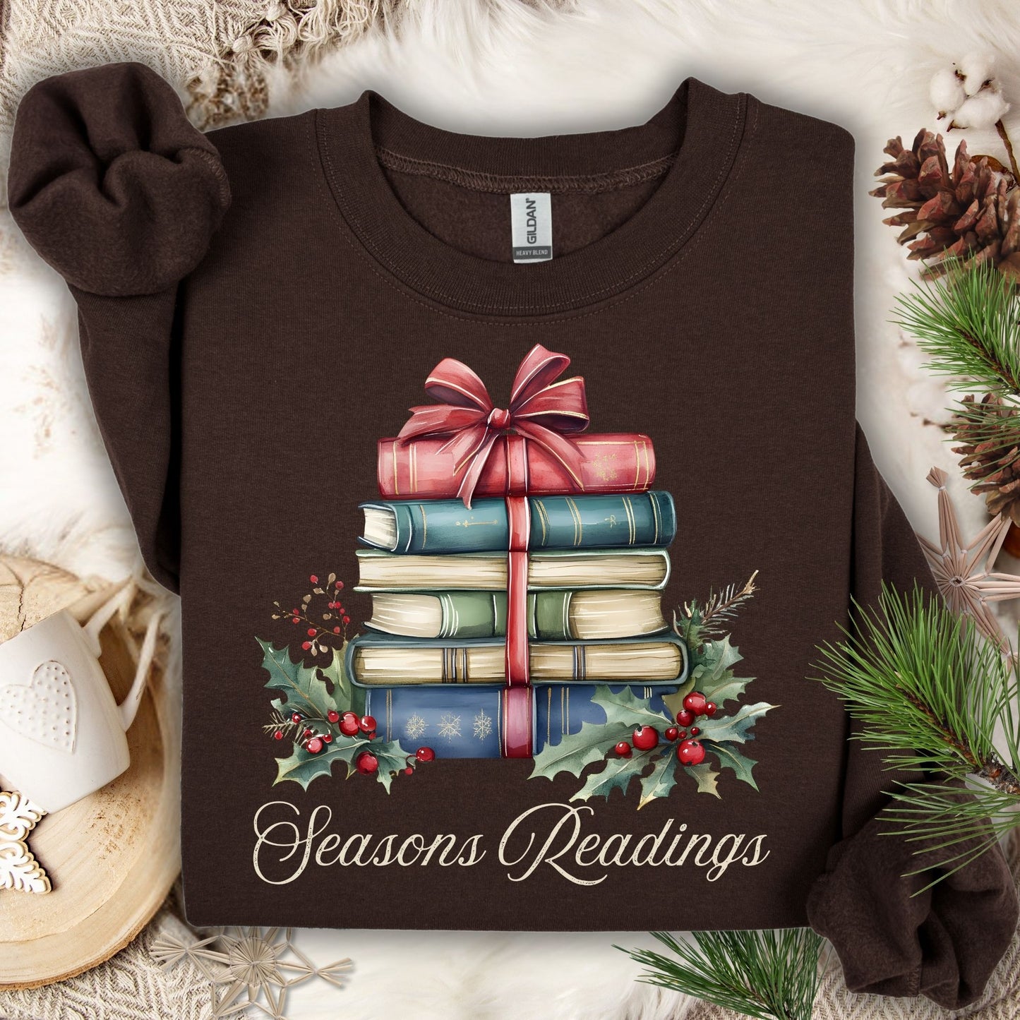 Dark chocolate Seasons Readings sweatshirt with a watercolor stack of Christmas books, holly, and pine.