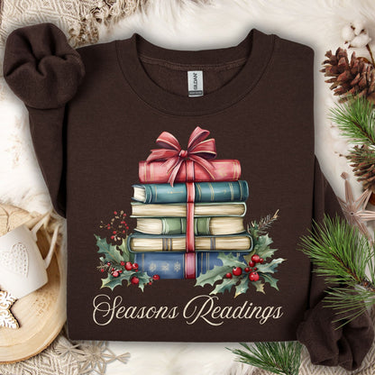 Dark chocolate Seasons Readings sweatshirt with a watercolor stack of Christmas books, holly, and pine.
