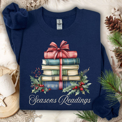 Navy fleece sweatshirt with watercolor vintage Christmas books, holly, and "Seasons Readings" text.