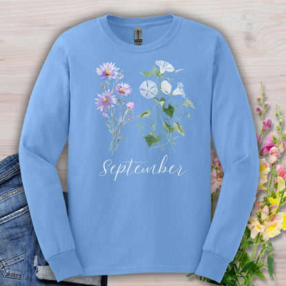 Carolina blue long-sleeve tee with watercolor aster and morning glory flowers, plus "September" script.