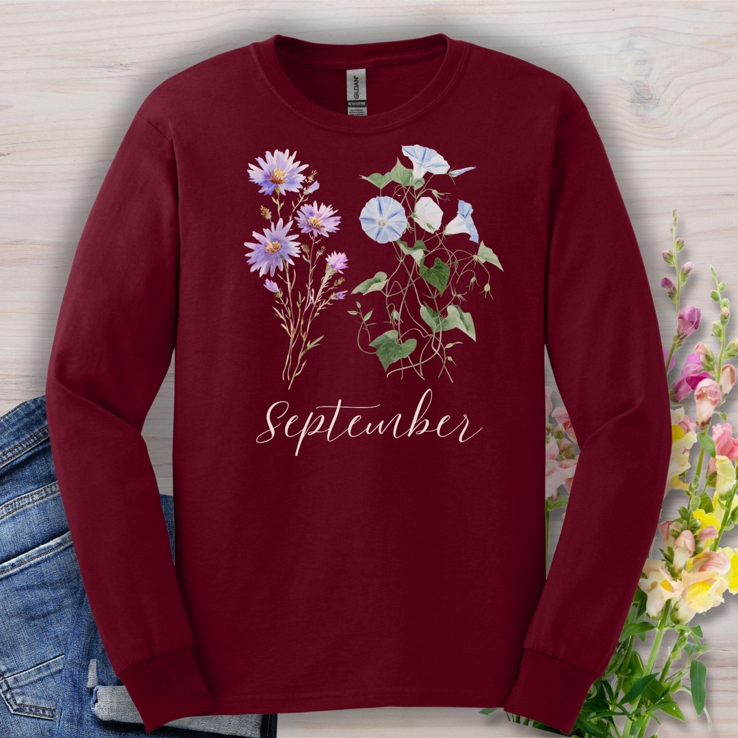 Maroon long-sleeve tee with watercolor asters, morning glories, and "September" script.