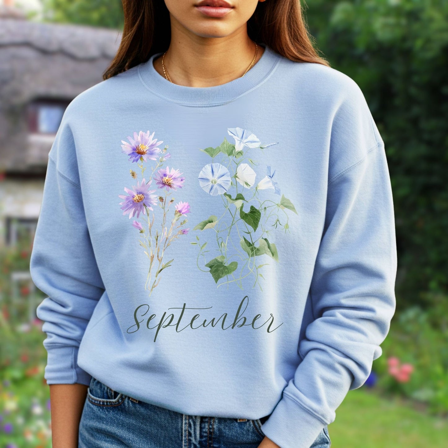 Light blue crewneck sweatshirt with watercolor morning glory and aster blooms, plus "September" script.