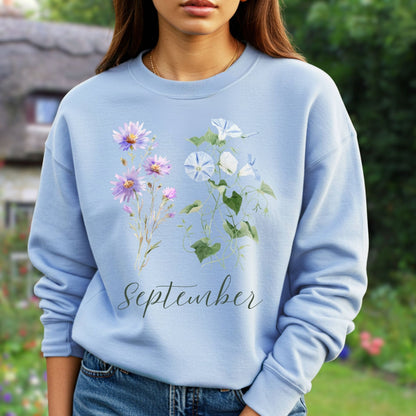 Light blue crewneck sweatshirt with watercolor morning glory and aster blooms, plus "September" script.