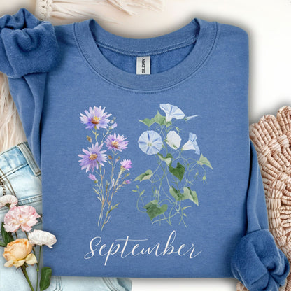Indigo blue crewneck sweatshirt with watercolor morning glory and aster flowers, plus "September" text.