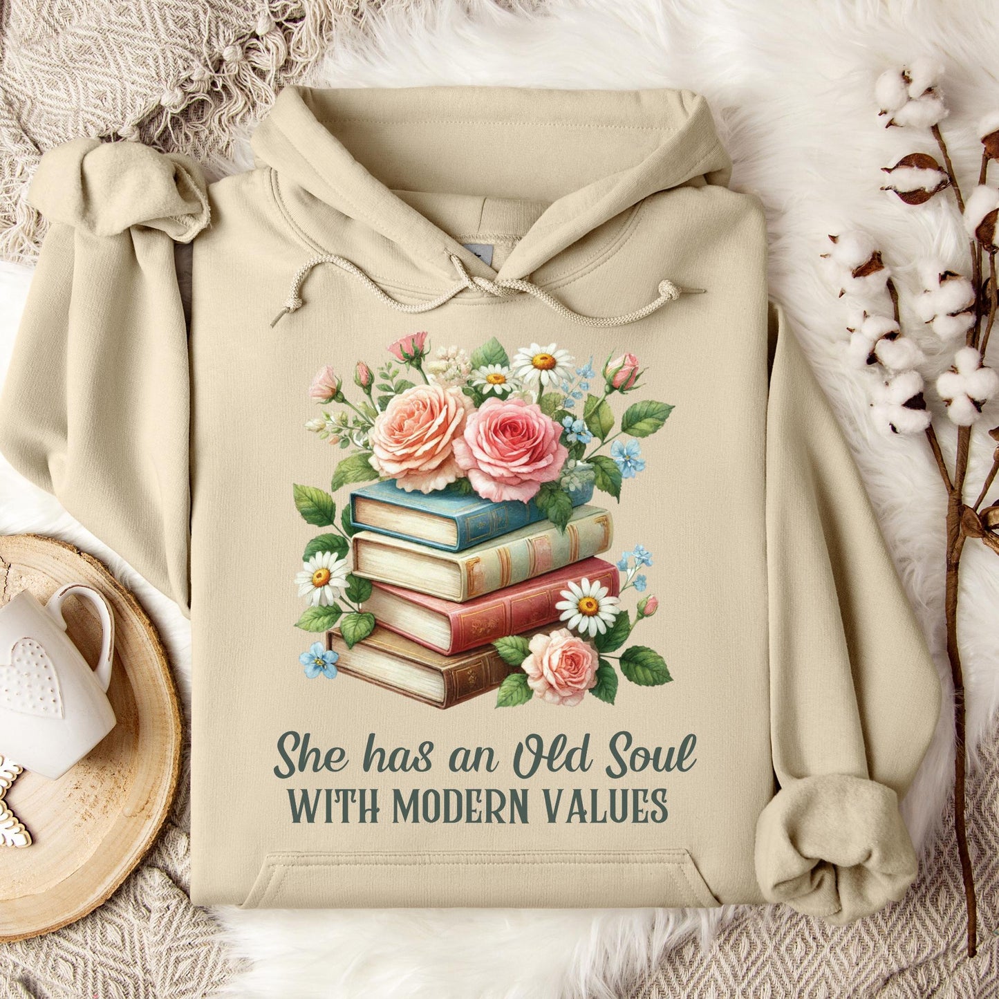 Sand Gildan 18500 hoodie with "She has an Old Soul with Modern Values" text and floral book stack graphic.