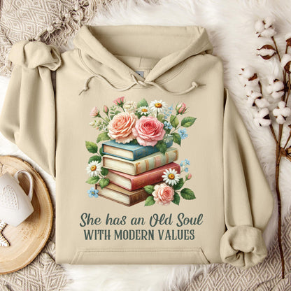 Sand Gildan 18500 hoodie with "She has an Old Soul with Modern Values" text and floral book stack graphic.