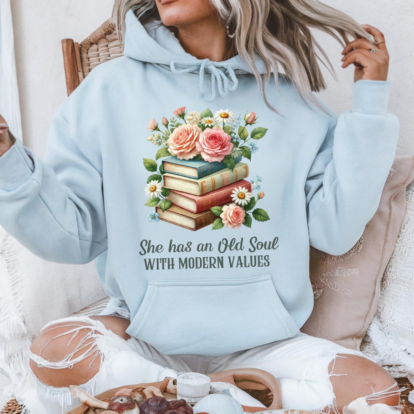 Light blue cotton-polyester hoodie with "She has an Old Soul with Modern Values" text and floral book stack graphic.
