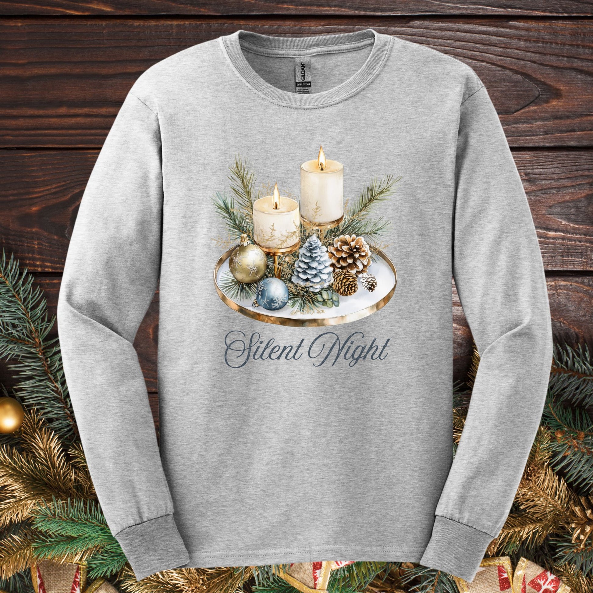 Ash S long sleeve tee with a watercolor Advent arrangement of candles, evergreens, and ornaments.