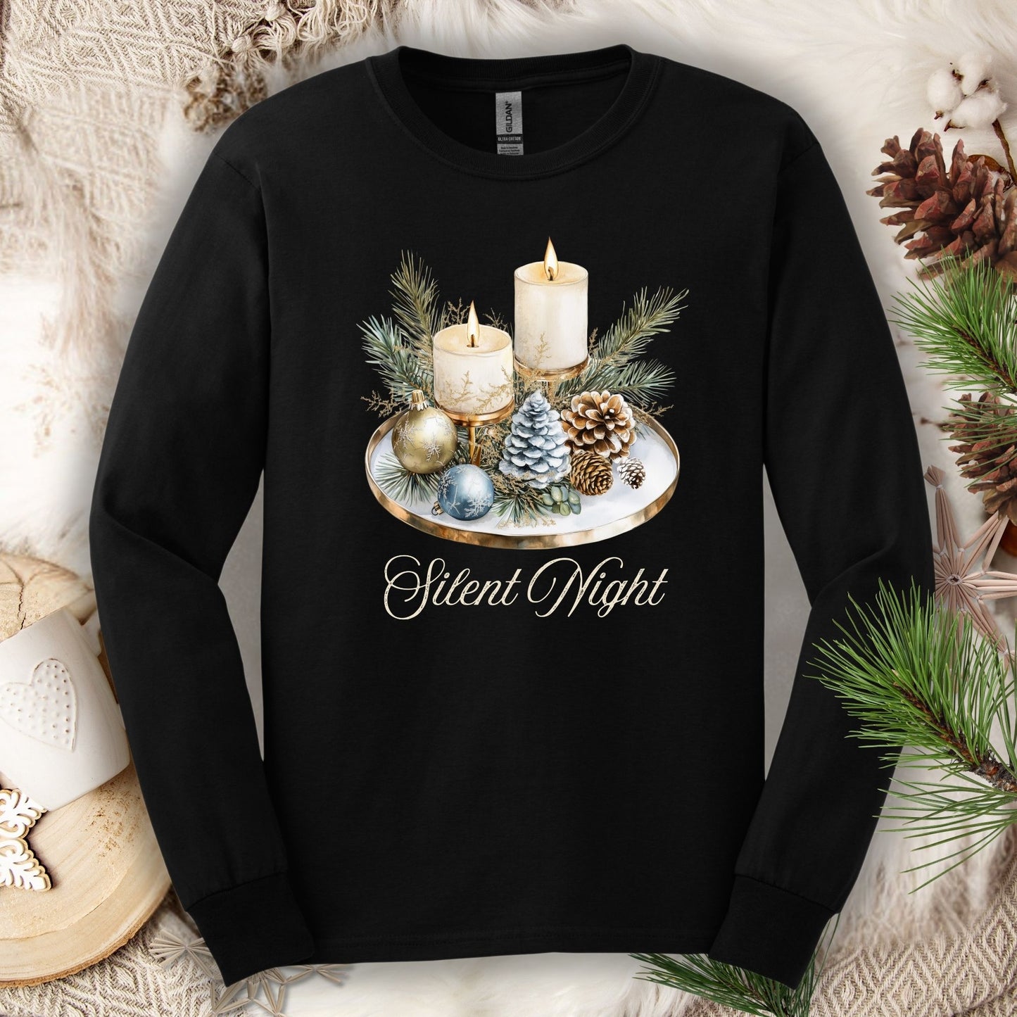 Black long sleeve tee with a "Silent Night" advent arrangement design featuring candles, evergreens, and ornaments.