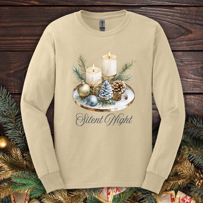 Sand long sleeve tee with a watercolor advent arrangement featuring candles, evergreens, ornaments, and "Silent Night.