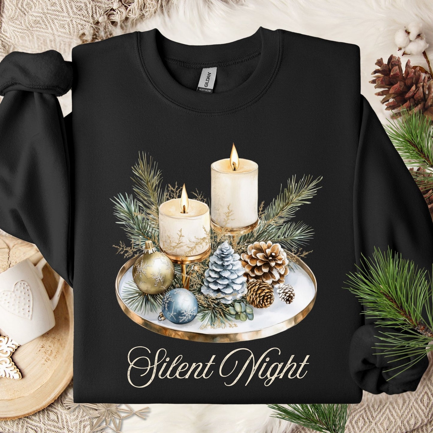 Black Gildan sweatshirt with watercolor advent candles, pinecones, and evergreens, plus "Silent Night" text.