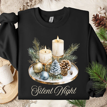 Black Gildan sweatshirt with watercolor advent candles, pinecones, and evergreens, plus "Silent Night" text.