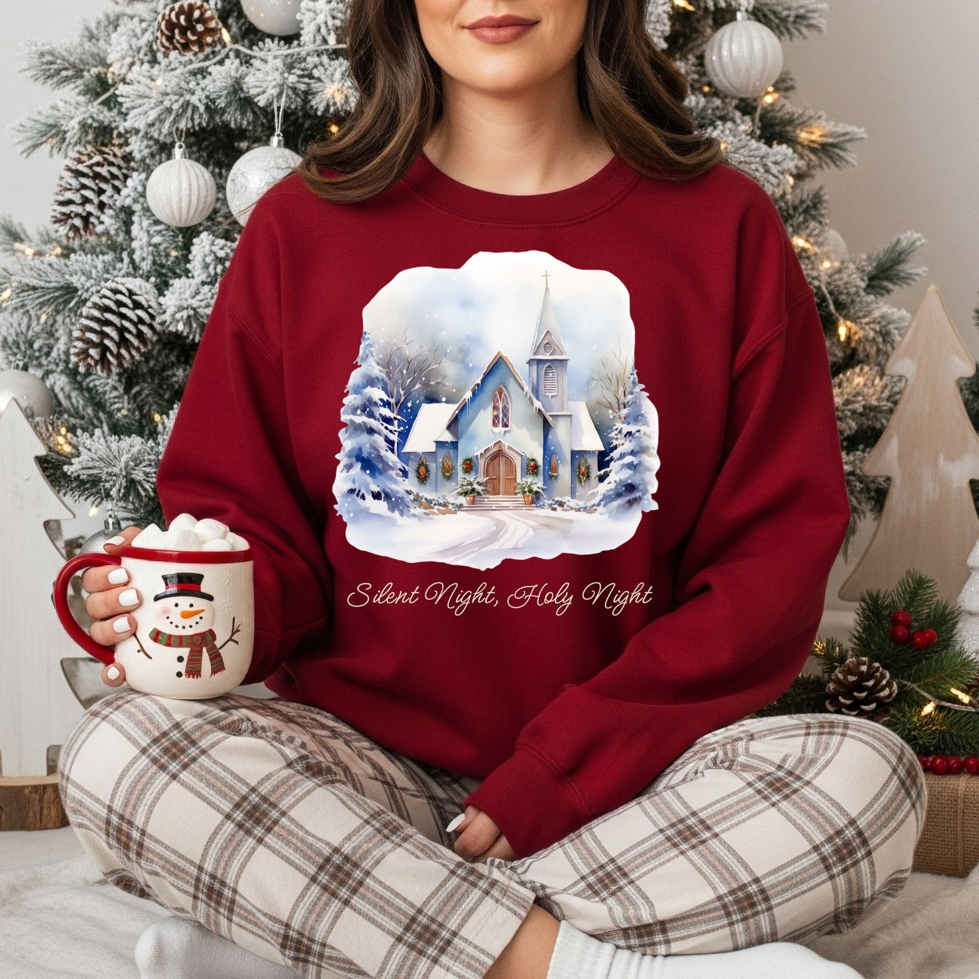 Red Gildan fleece sweatshirt with a snowy country chapel design and "Silent Night, Holy Night" text.