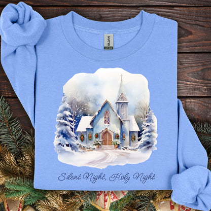 Carolina Blue Gildan fleece sweatshirt with a snowy chapel design, evergreen garlands, and "Silent Night, Holy Night" text.