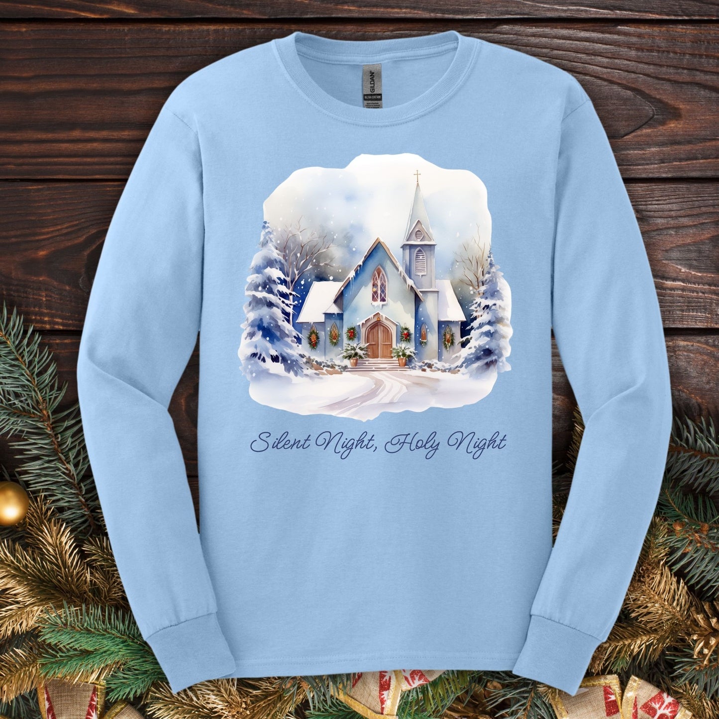 Light blue long sleeve tee with a watercolor snow-covered chapel and "Silent Night, Holy Night" text.
