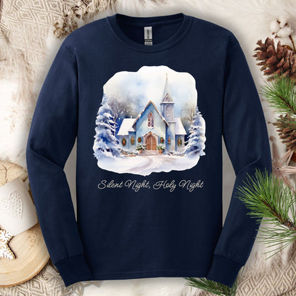 Navy long sleeve tee with a watercolor snow-covered chapel, festive greenery, and "Silent Night, Holy Night.
