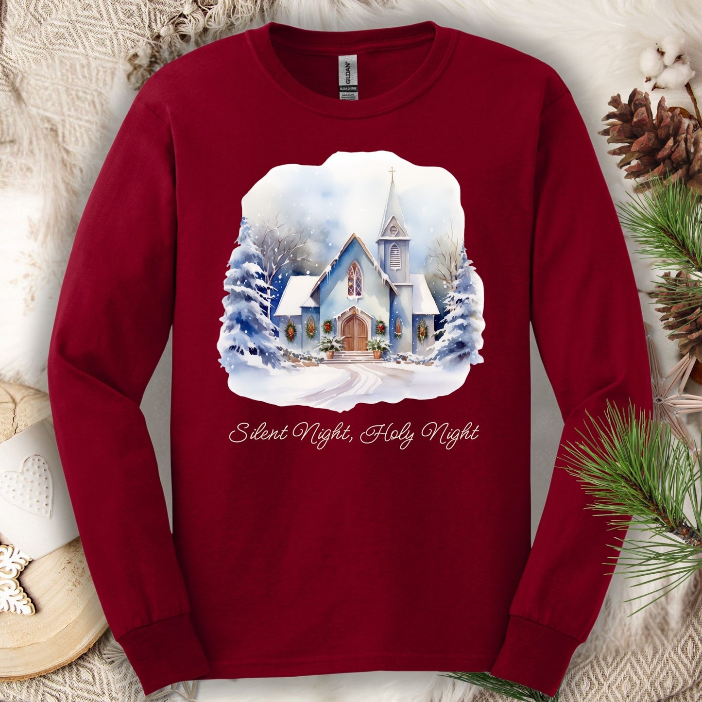 Cardinal Red long sleeve tee with a watercolor snow-covered country chapel and "Silent Night, Holy Night" text.