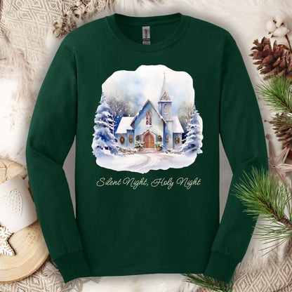 Forest Green long sleeve tee with watercolor snow-covered chapel, festive greenery, and "Silent Night, Holy Night" text.