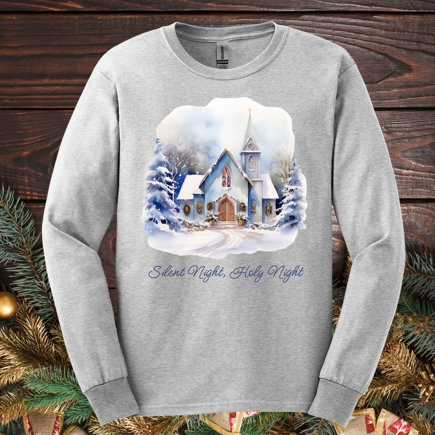 Ash long sleeve tee with a watercolor snow-covered country chapel and "Silent Night, Holy Night" text.