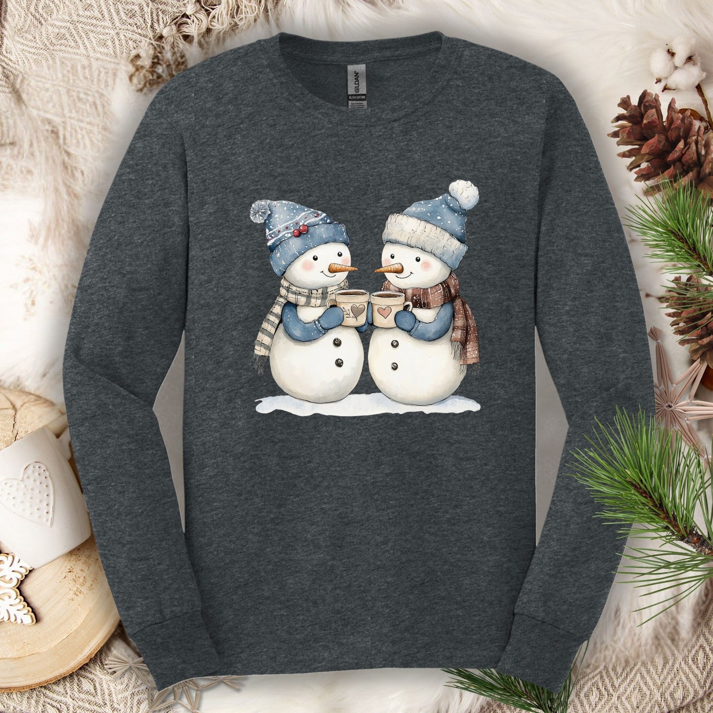 Dark Heather long sleeve tee with two snowpeople in blue hats and scarves drinking hot chocolate.