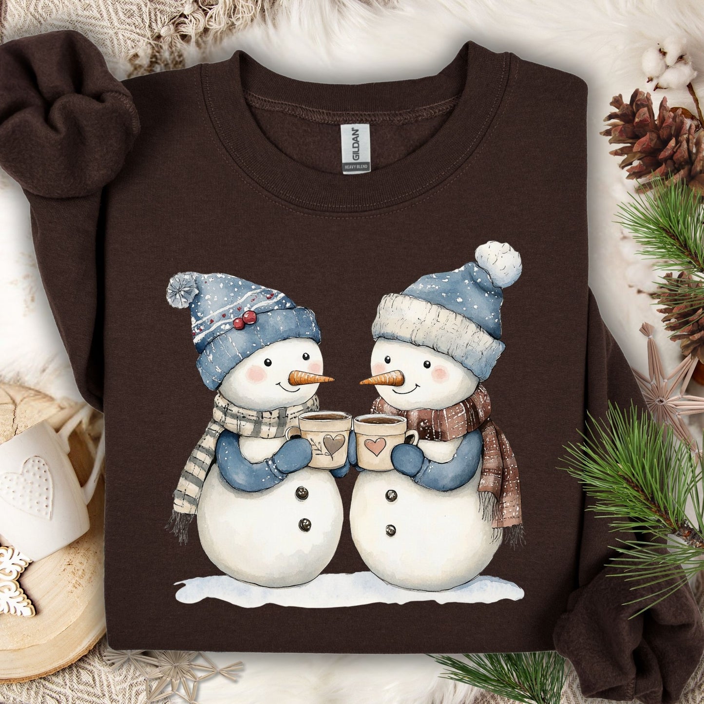 Dark Chocolate Snow Couple in Love sweatshirt with two snowpeople in blue hats, scarves, holding hot chocolate.