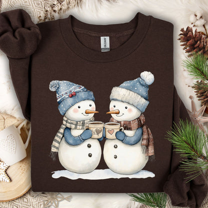 Dark Chocolate Snow Couple in Love sweatshirt with two snowpeople in blue hats, scarves, holding hot chocolate.