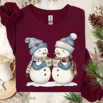 Maroon cotton-polyester sweatshirt with two snowpeople in blue hats and scarves, holding hot chocolate.