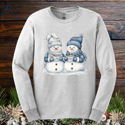 Ash long-sleeve tee with two snowmen in blue and gray hats, scarves, holding hot chocolate.