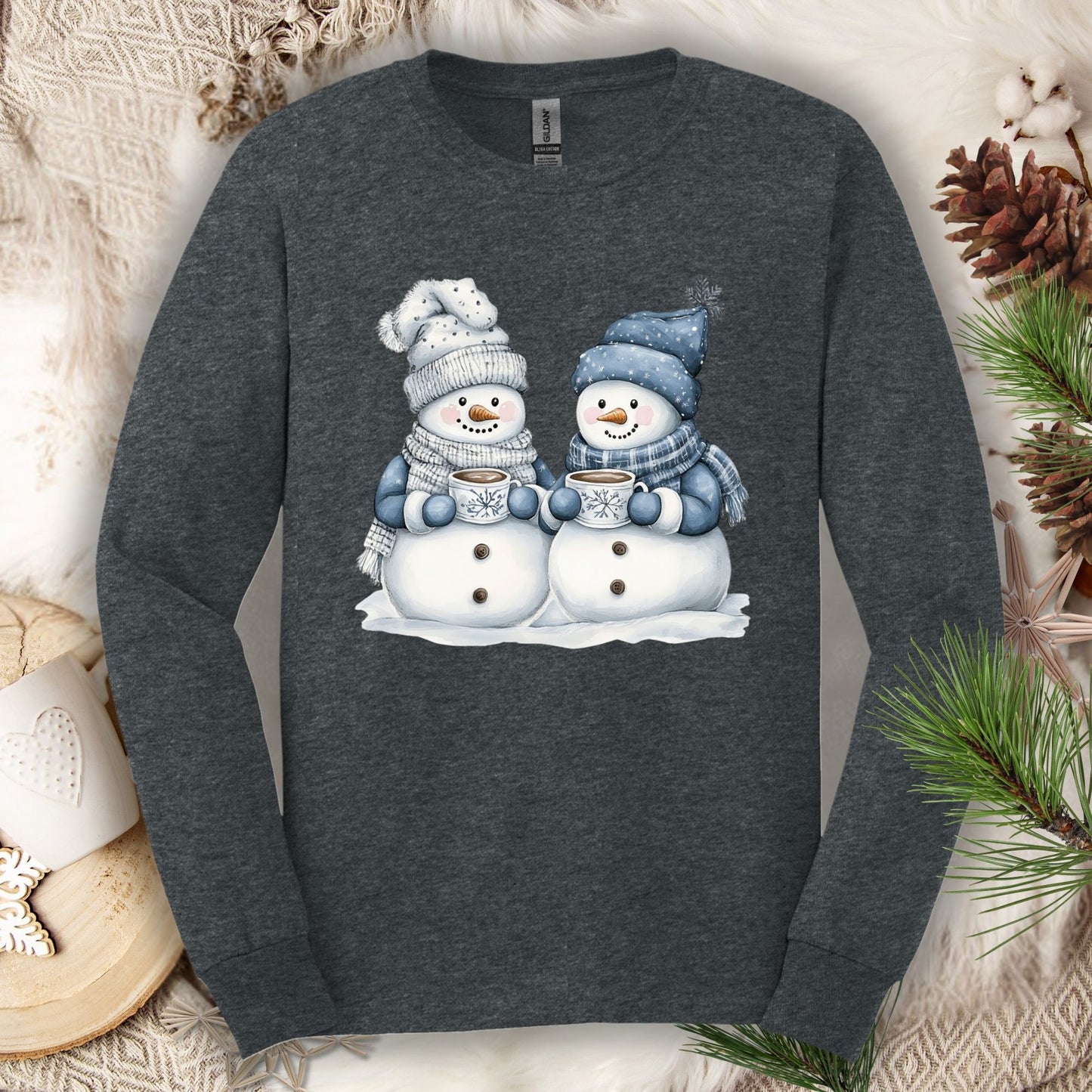 Dark Heather long-sleeve tee with two snowmen in blue and gray hats and scarves holding hot chocolate.
