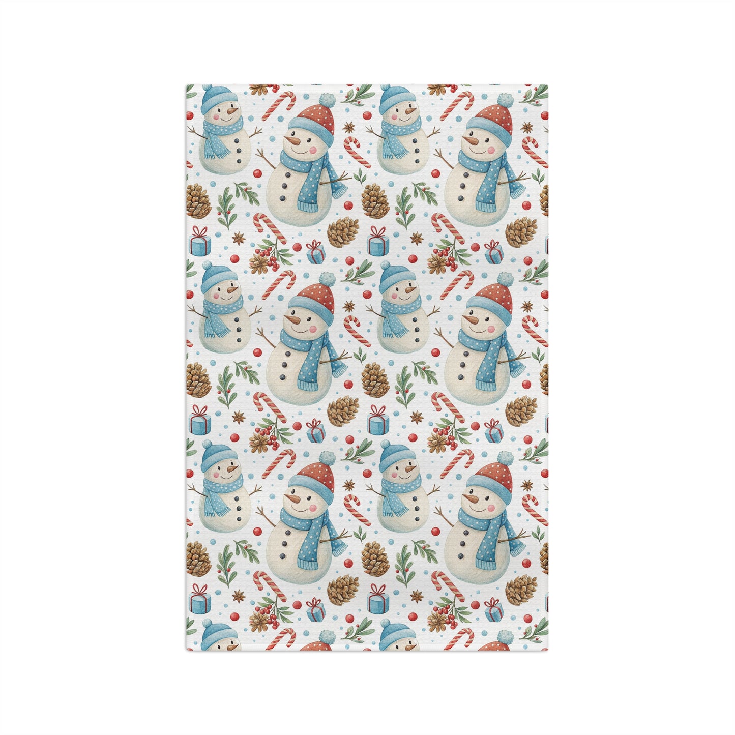 Holiday microfiber tea towel with a pattern of snowmen, candy canes, pine cones, and holly on white.