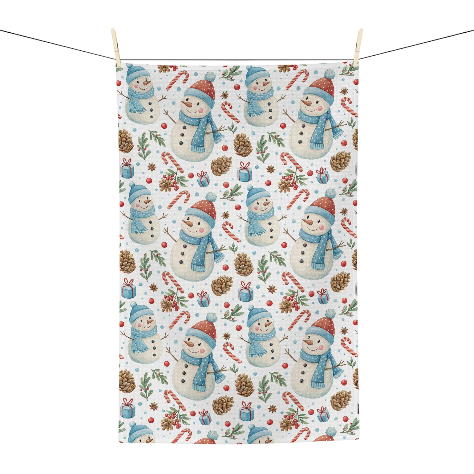 White microfiber tea towel with a repeating pattern of snowmen, candy canes, pine cones, and holly.