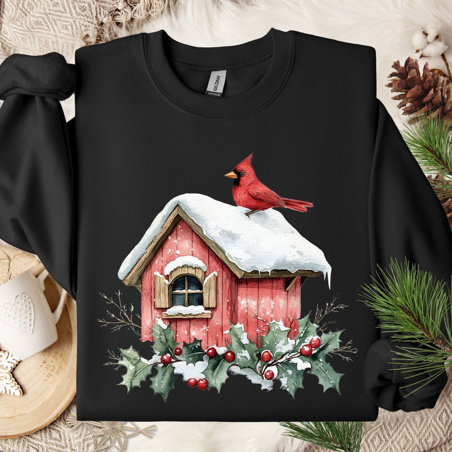 Black Gildan sweatshirt with a watercolor red cardinal on a snow-covered birdhouse, holly, and berries.