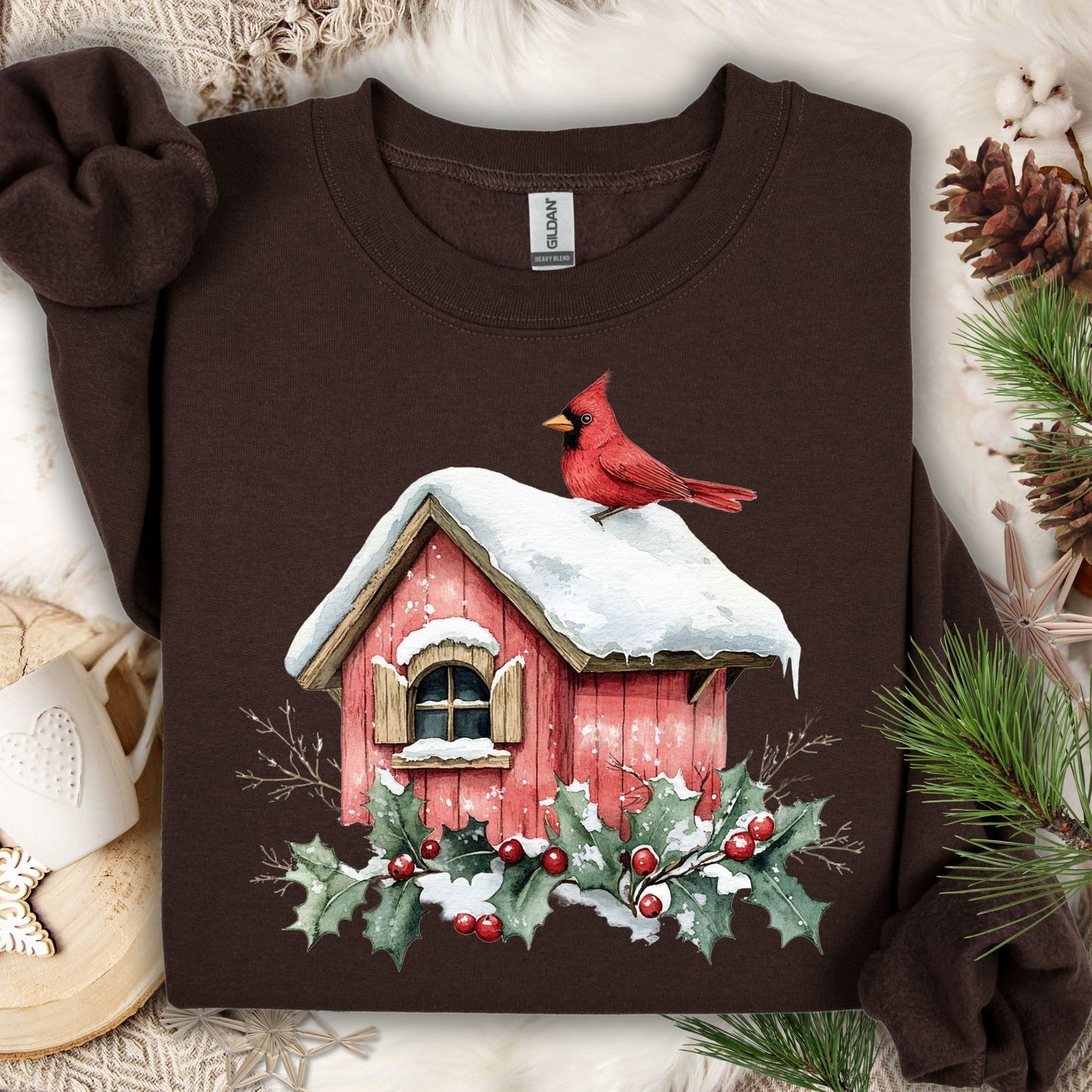 Dark chocolate Gildan fleece sweatshirt with a watercolor cardinal on a snowy birdhouse, holly, and berries.