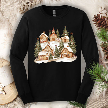 Black long sleeve tee with a watercolor snowy gingerbread village and evergreen trees design.