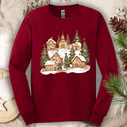Cardinal Red long sleeve tee with a watercolor snowy gingerbread village and evergreens.