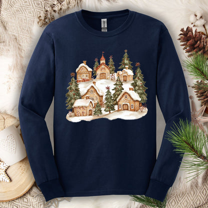 Navy long sleeve tee with a watercolor snowy gingerbread village and evergreens.